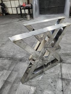 a metal sculpture sitting on top of a cement floor