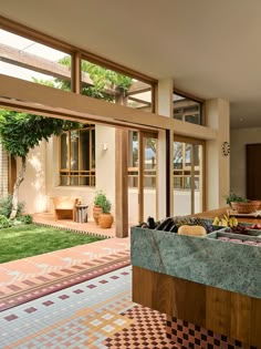 a kitchen with an outdoor dining area and large windows