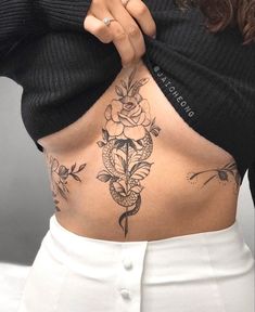 a woman with tattoos on her stomach