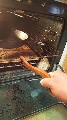 a person is pulling something out of an oven