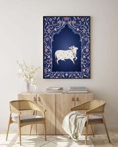 two chairs in front of a cabinet with a cow painting on it's wall