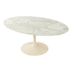 an oval marble table with a white base