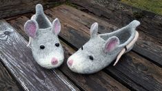 two stuffed mouses sitting on top of a wooden bench