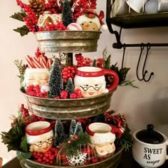 three tiered trays filled with christmas decorations