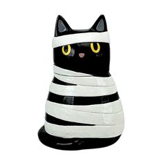 a black and white cat statue with yellow eyes