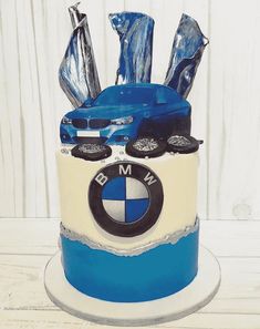 a blue and white bmw cake with silver decorations