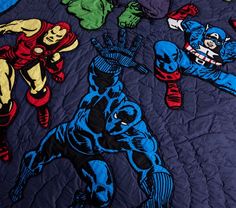 the avengers quilt is on display in front of an image of iron man and captain america