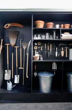 a shelf filled with lots of different types of gardening utensils and other items