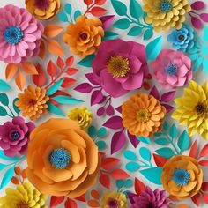 colorful paper flowers are arranged on a white surface