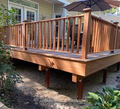 a wooden deck with an umbrella over it