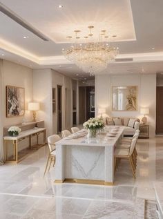 an elegant dining room with marble flooring and chandelier hanging from the ceiling