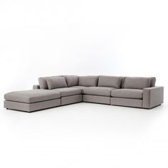 a large sectional couch with pillows on the top and bottom corner, in grey fabric