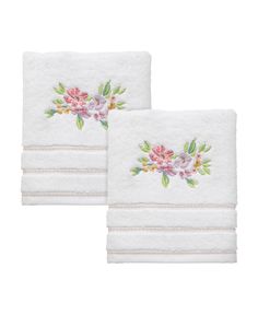 two white towels with pink flowers on them