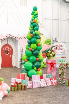 a christmas tree made out of balloons and presents