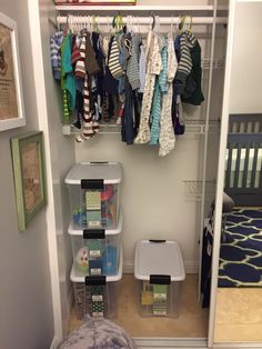 an organized closet with clothes hanging on the rack and baby's diapers in bins