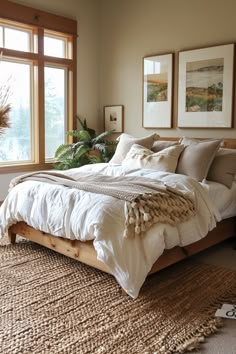 a large bed sitting in a bedroom next to two windows and a rug on the floor