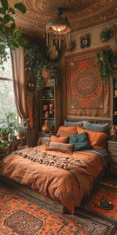 a bed with an orange bedspread in a room filled with plants and decorations