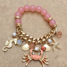 Gold Tone Bracelet Features A Nautical Beach Theme Of Charms. A Gold Tone Matte Finish Statement Link Chain Features A White Faux Pearl Charms, Coral Bead Charms, A Seahorse, Clam Shell, Starfish And A Stunning Coral Enamel And Crystal Crab. The Coral Beads On The Other Half Of The Bracelet Are Strung On Elastic, Bracelet Stretches Over The Hand Onto The Wrist. Crab Measures 1 3/8 Inch L X 1 3/8 Inch W. Adjustable Charm Bracelet With Round Beads For Beach, Acrylic Nails Almond Shape, Acrylic Nails Almond, Nails Almond Shape, Taco Party, Coral Bracelet, Nautical Jewelry, Beads Bracelet Design, Almond Shape