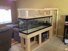 a fish tank sitting in the middle of a living room