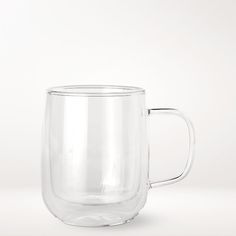 a clear glass mug with handle on a white background, it appears to be empty