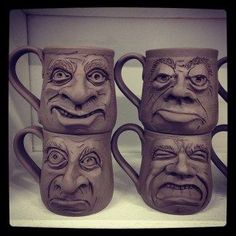 four mugs with faces drawn on them