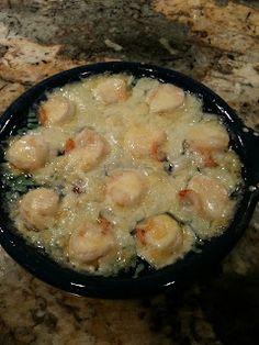 a black bowl filled with food on top of a counter