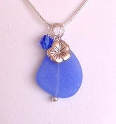 FREE SHIPPING!  Handmade in the USA!  “Cultured sea glass is made from recycled glass. As with stones found on the beach, each bead may vary slightly in shape and color making each piece beautifully unique!”  Handmade Pendant / Necklace - Cultured recycled sea glass, beach glass! Stunning 1 1/8" OPAQUE SKY BLUE large cultured sea glass  flat bead accented with coordinating crystal bead and cultured pearl.  Pendant length from chain is about 1 3/4 inches. Includes silver plated 18" chain.  Custom orders welcomed. For more great designs please visit: http://www.stores.ebay.com/hookedondesigns (NOTE: Colors may vary slightly when viewed on different devices.) 925 Silver Plated chain. Beach Glass Necklace, Jewel Of The Seas, Artisan Jewelry Necklaces, Handmade Pendant Necklace, Glass Beach, Sea Glass Beach, Beachglass Jewelry, Color Making, Sea Glass Pendant