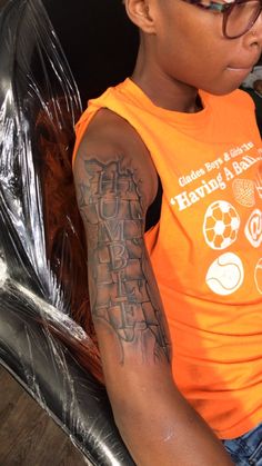 a young boy wearing glasses and an orange shirt