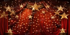 an empty stage with red curtains and gold stars