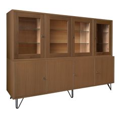 a wooden cabinet with glass doors and metal legs on the bottom shelf is shown against a white background