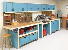 an organized garage with blue cabinets and tools