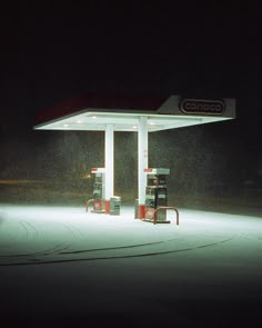 a gas station at night with the lights on