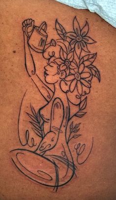 a woman with flowers on her back tattoo