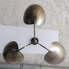 a metal light fixture hanging from the ceiling