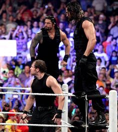 two men standing on top of a wrestling ring