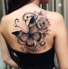 a woman with a butterfly and flower tattoo on her back