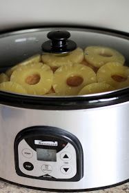 a slow cooker filled with sliced pineapples on top of a granite counter