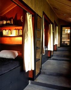 the bunk beds are lined up against the wall with bookshelves on each side