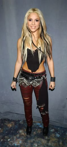 a woman with long blonde hair and leather pants