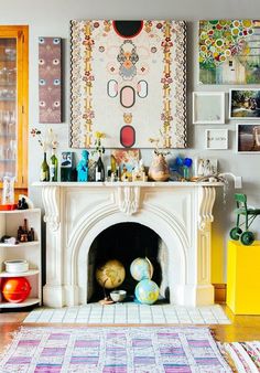 a living room filled with furniture and a fire place in front of a painting on the wall