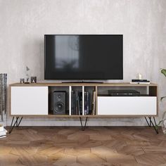 an entertainment center with a television and speakers