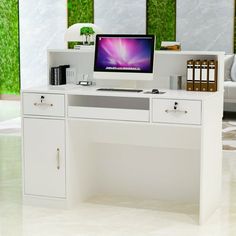 a white desk with a computer on it