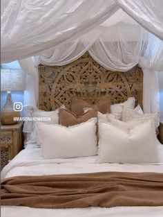 the bed is made with white and brown pillows