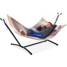 a man is laying in a hammock