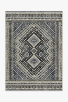 a rug with an intricate design in grey and white colors, on a gray background