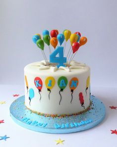 a birthday cake with balloons and the number four on it