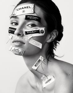 a woman with tape on her face and the words chanel taped all over her face