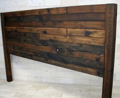 a wooden headboard made out of wood planks in a room with white tile flooring