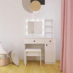 a white vanity with lights on it and a stool in front of the mirror, next to a pink curtain