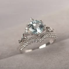 * The delicate ring displays aquamarine as main stone. The curved band beneath the gemstone makes the ring like an elegant crown.  For who wearing this dainty ring, will shine like a queen.  ◆ Production Description: Main stone Type: Aquamarine Main Stone Shape: Round Cut Main Stone Size: 7*7mm Side stone: CZ Metal: 925 Sterling silver - Other options available in the drop down menu ◆ Customization: √Free for Add Engraving  √Other Metal Type Available √Other Gemstones & Shapes Available  √Person Eternity Band Engagement Ring, Fairytale Ring, Elegant Crown, Cute Promise Rings, Cute Engagement Rings, Future Engagement Rings, Zierlicher Ring, Dream Engagement Rings, Aquamarine Ring